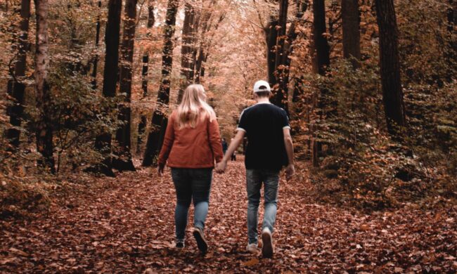 couple walking in Fall woods