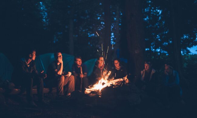 Group talking around campfire