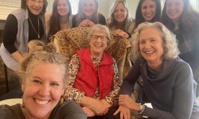9 women, 3 generations, smiling