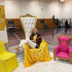 Woman sitting sideways in throne
