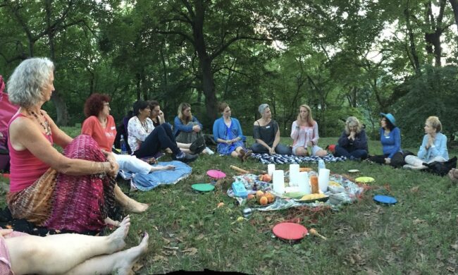 Women sitting in a circle outside